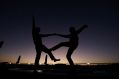 Two people dancing together are silhouetted against the darkening sky. arts sector appointments