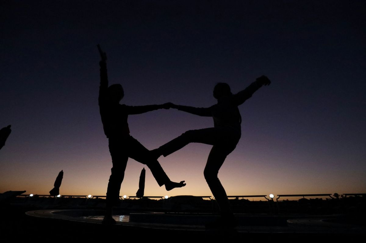 Two people dancing together are silhouetted against the darkening sky. arts sector appointments