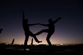 Two people dancing together are silhouetted against the darkening sky. arts sector appointments