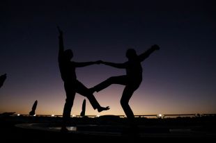 Two people dancing together are silhouetted against the darkening sky. arts sector appointments