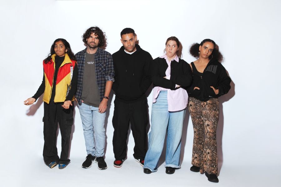 The cast of Artefact (or, Repatriation: The Musical), a work-in-progress musical showing at the 2026 Adelaide Cabaret Festival. Five performers stand closely together, as if lined up for a police identity parade.
