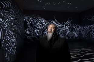 Brian Robinson with his work Zugubal at Newcastle Art Gallery, 2026. Photo: Peter Stoop.