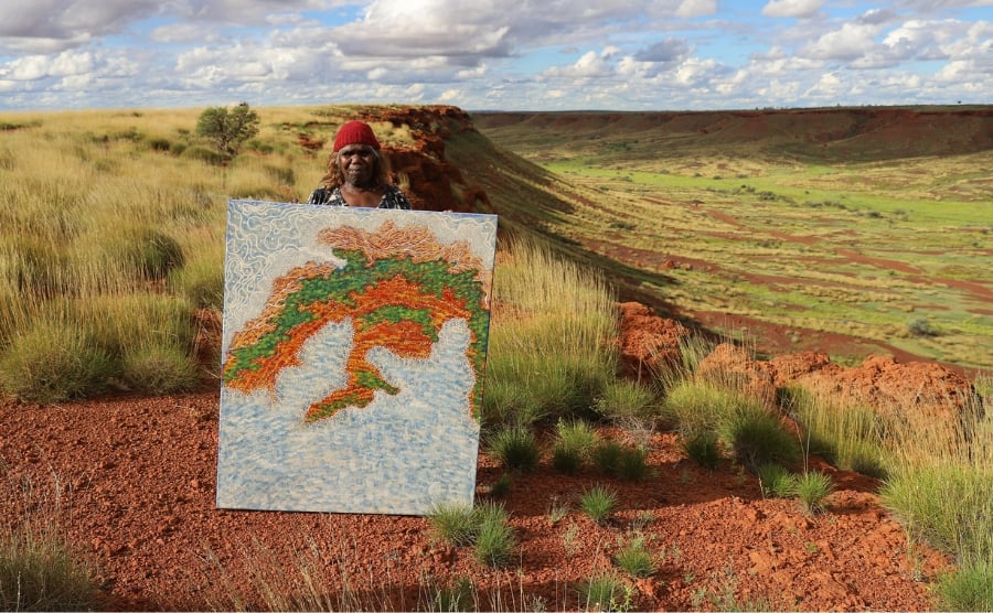 Artist Dulcie Nanala at Balgo Hills. Warlayirti Artists is one of 80 art centres exhibiting at the 2026 Darwin Aboriginal Art Fair. Photo: Britt Pfeiffer / Warlayirti Artists.