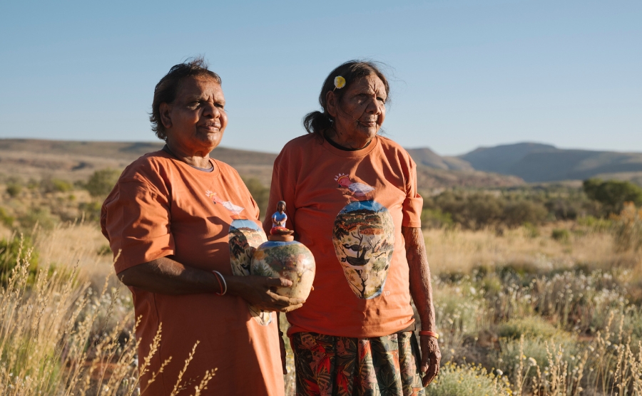 Hayley Coulthard and Anita Ratara with Mbitjana Ceramic. Hermannsburg Potters is one of 80 art centres exhibiting at the 2026 Darwin Aboriginal Art Fair. Photo: Alana Holberg / Hermannsburg Potters.