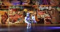 Iconic Victorian company Snuff Puppets has had its annual funding of $112,000 cut by Creative Victoria. Pictured is the Snuff Puppets' popular character Skullie, 2020. A person dressed in a skeleton costume sits at a wooden desk in an old hall. Racks of puppet parts and costume are stored behind it.