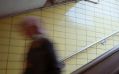 A blurred figure hurries down a tiled staircase, perhaps to catch a train. arts sector appointments