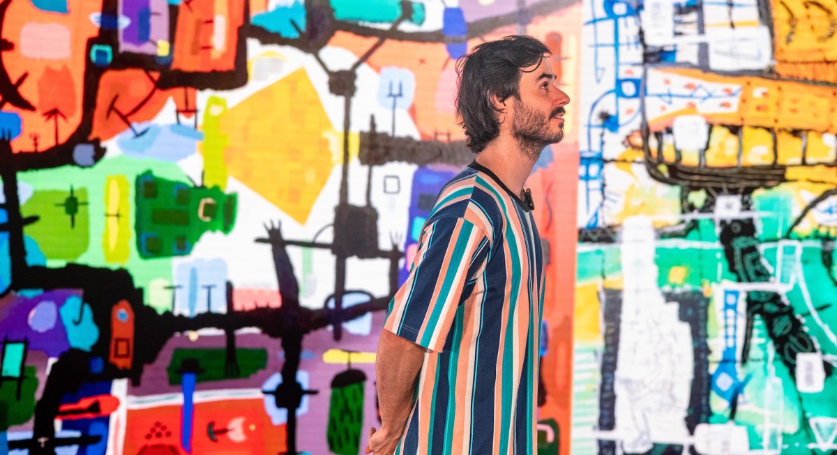 Sam Kissajukian in front of his art during a performance of 300 Paintings. Photo: Sarah Findlay.