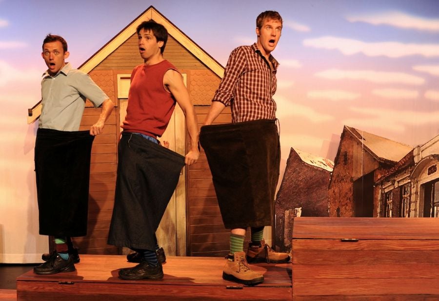 Monkey Baa Theatre's The Bugalugs Bum Thief. Three fair-skinned male presenting actors gasp in shock as they hold up their pants, suggesting their bums have been stolen.