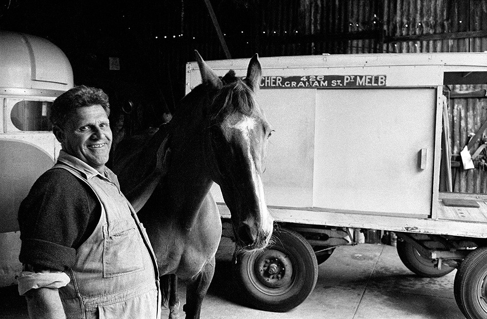 ‘When I was a child, back in the late 1950s, it wasn’t uncommon to have a horse drawn “Milko” and also a Bread Cart delivering to homes daily. But time moves on and by the late 1970s there were very few left around Melbourne’s suburbs … Port Melbourne Milkman Claude Butcher and his horse in his Graham St Shed, 1979. In all his years, he told me, he had never travelled outside Port or South Melbourne, something that is hard to believe in this day and age.” Andrew Chapman, Last of the horse-drawn milkmen, Graham Street, Port Melbourne, 1979. Gelatin silver print, City of Melbourne Art and Heritage Collection. Courtesy: Andrew Chapman Photography.