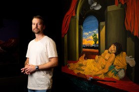 Ryan Presley with his winning Telstra Art Award painting, Our lifestyle of tranquillity undisturbed (2026), oil on canvas. Photo: Charlie Bliss.